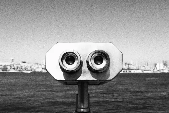 grayscale photo of binoculars on the ground